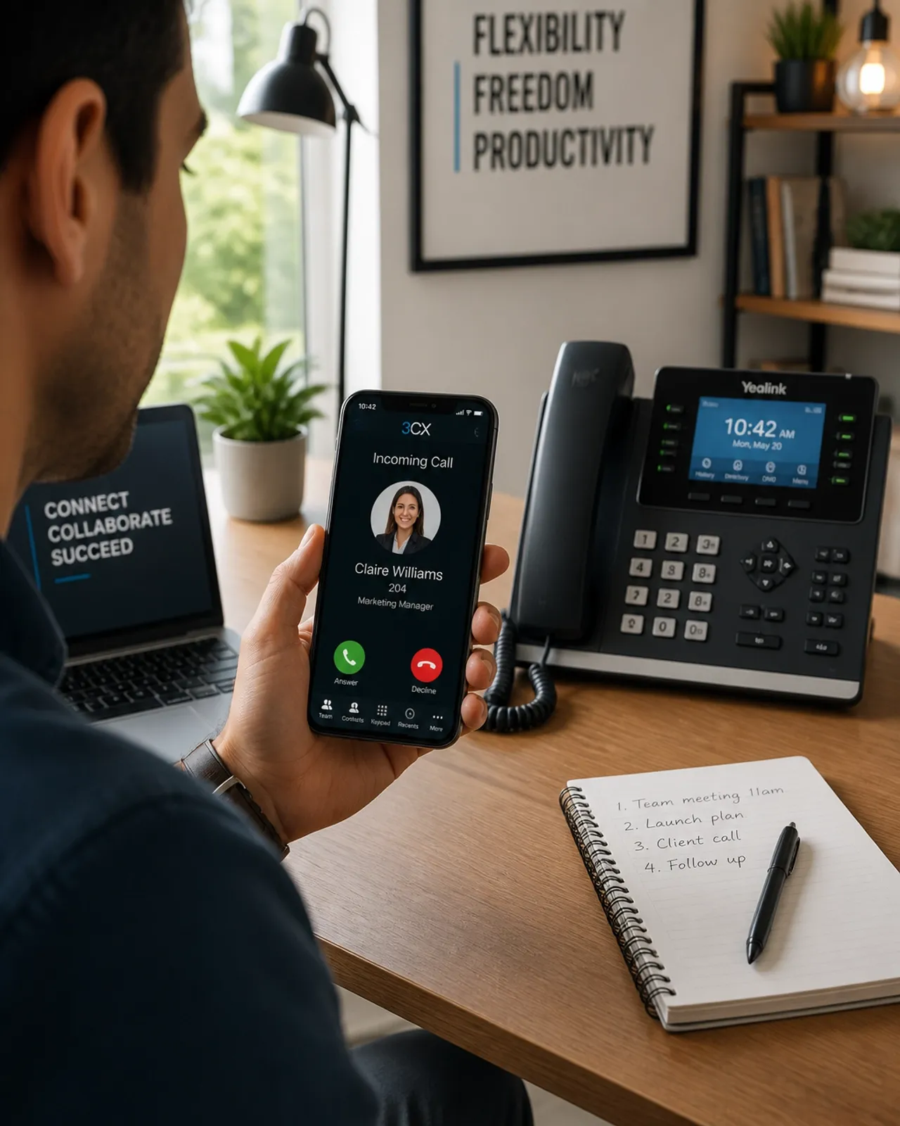 Person using a mobile VoIP app with a desk phone in the background