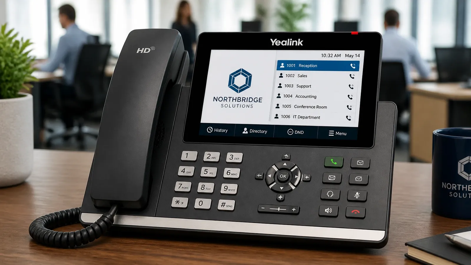 A close-up of a professional Yealink IP phone on a modern desk, showing a high-resolution color screen and multiple line keys.
