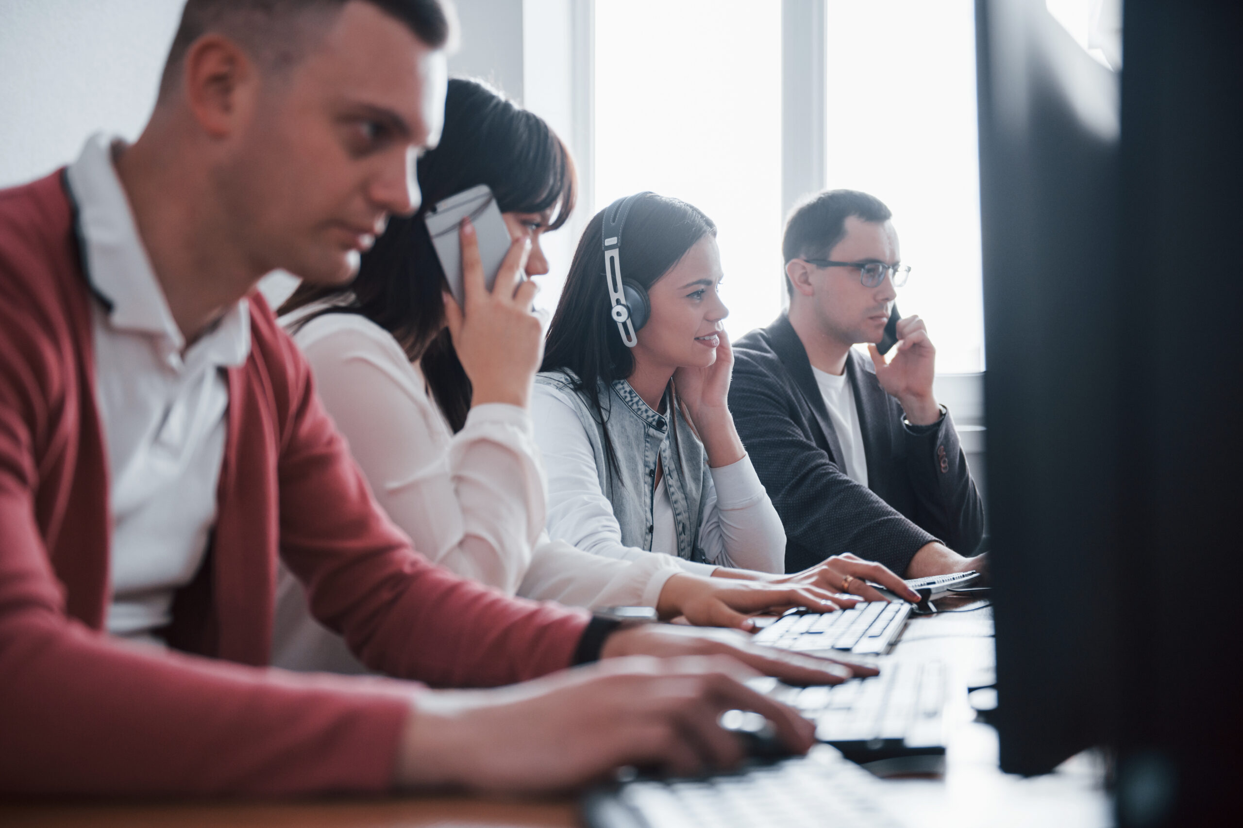 - Voiswitch Corporate business. Young people working in the call center. New deals is coming