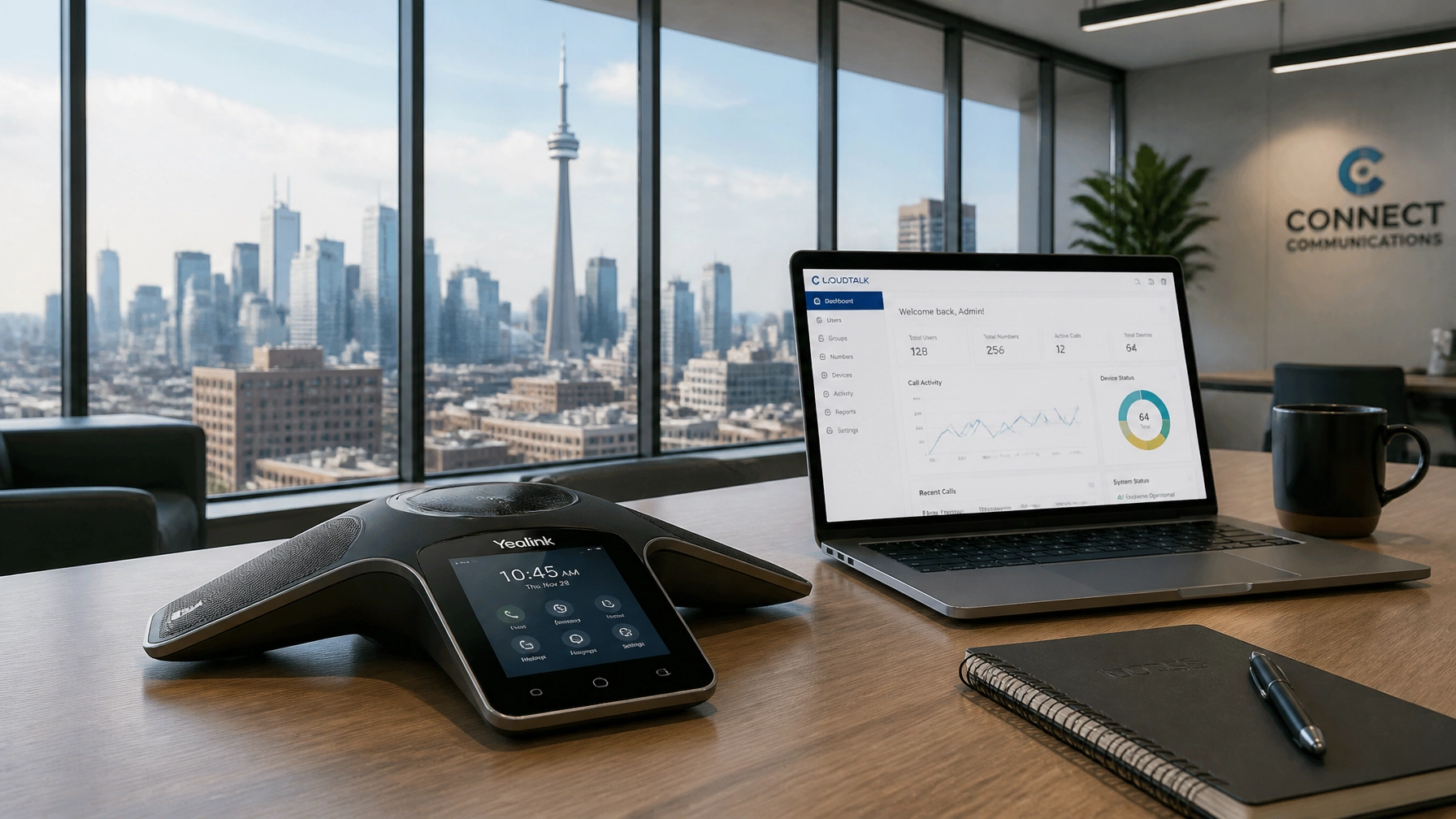 8-JiRHthmIL - Voiswitch - Voiswitch Conference room desk with a Yealink speakerphone, open laptop showing an analytics dashboard, a notebook and mug, against a cityscape through large windows.